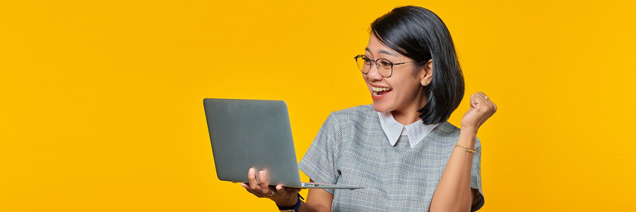 A woman is holding a laptop.