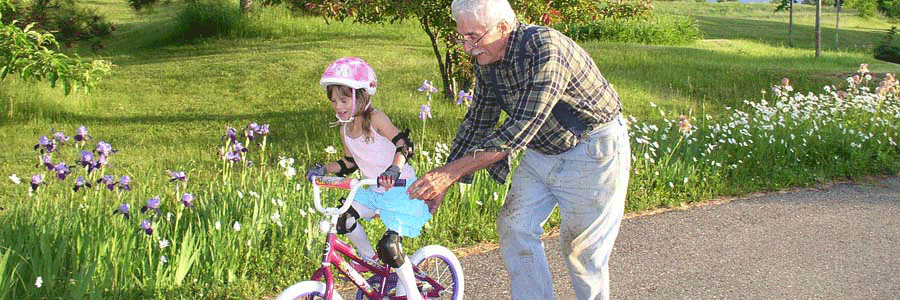 Grandpa teaching child to bike