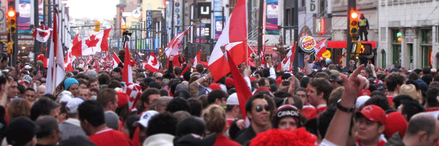 Crowd holding Canadian flags