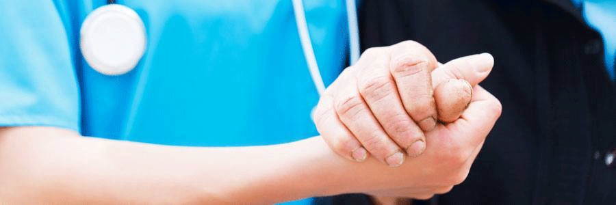 Health care worker holding the hand of a patient