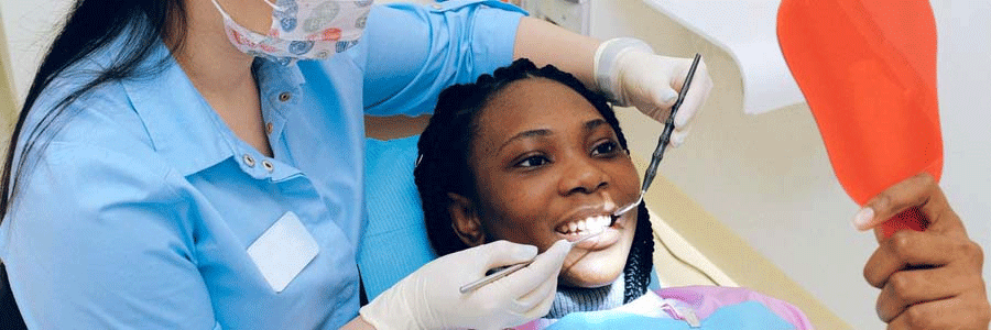 Dentist checking patient's teeth